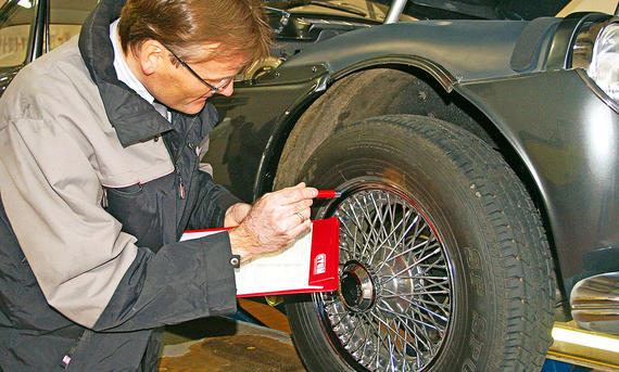 Ein Oldtimer-Gutachter prüft einen Oldtimer-Reifen